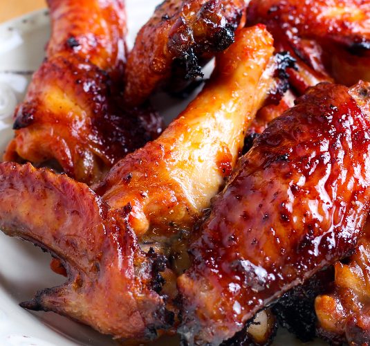 Sweet and sticky chicken wings in a bowl