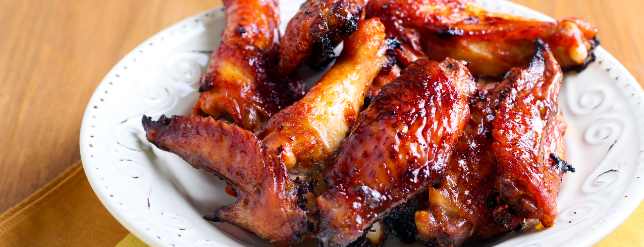 Sweet and sticky chicken wings in a bowl