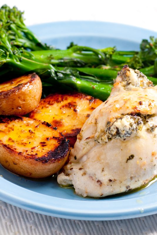 goat cheese and spinach stuffed chicken breast with vegetables