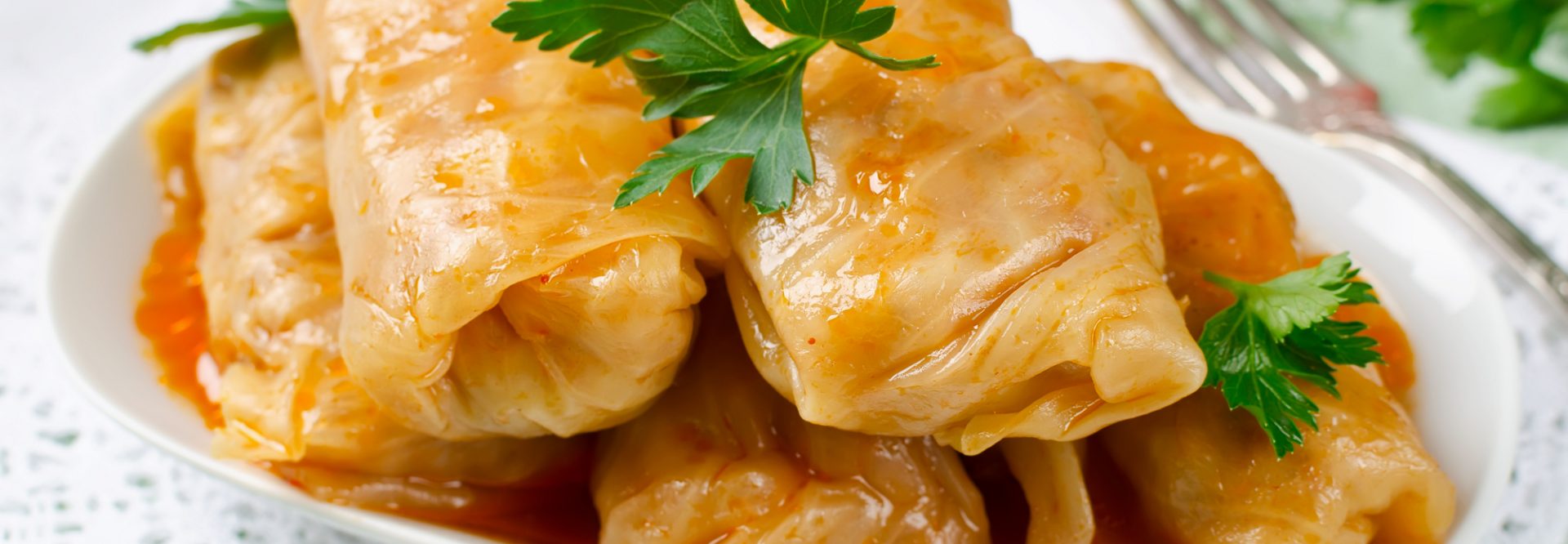 Stuffed cabbage rolls with rice and meat in tomato sauce