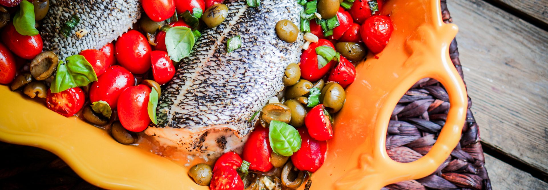 Baked Seabass With Tomatoes And Basil On Rustic Wooden Background