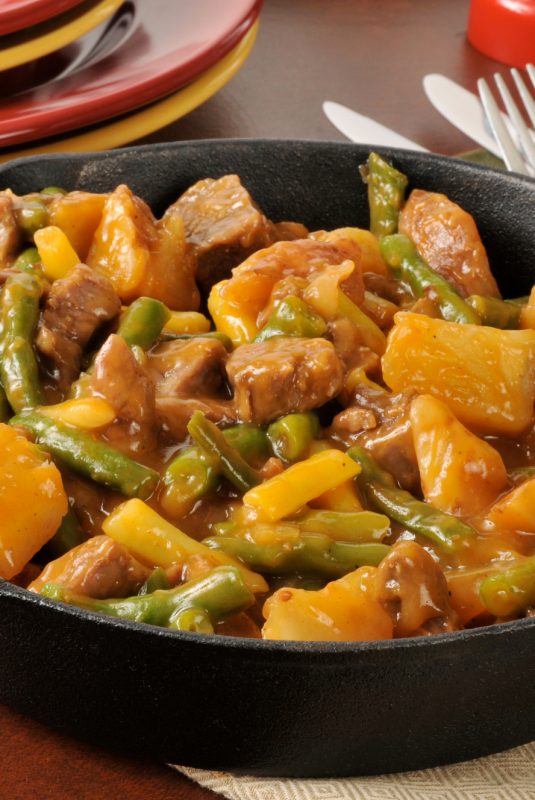 A skillet dinner with braised beef, potatoes and beans