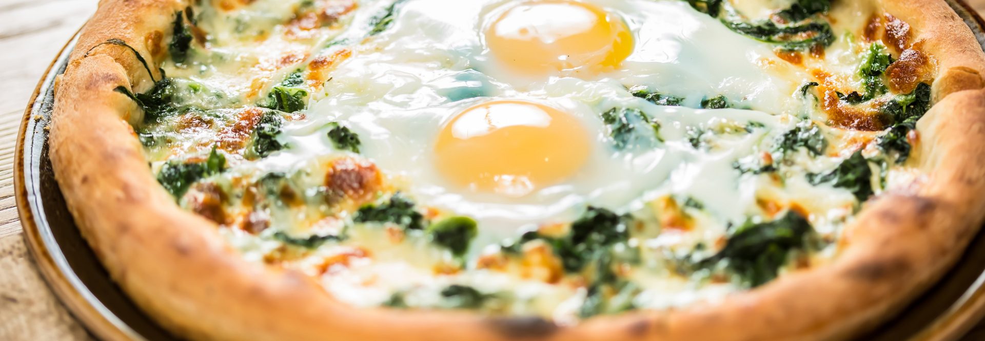 Margarita pizza with arugula and egg for breakfast, selective focus