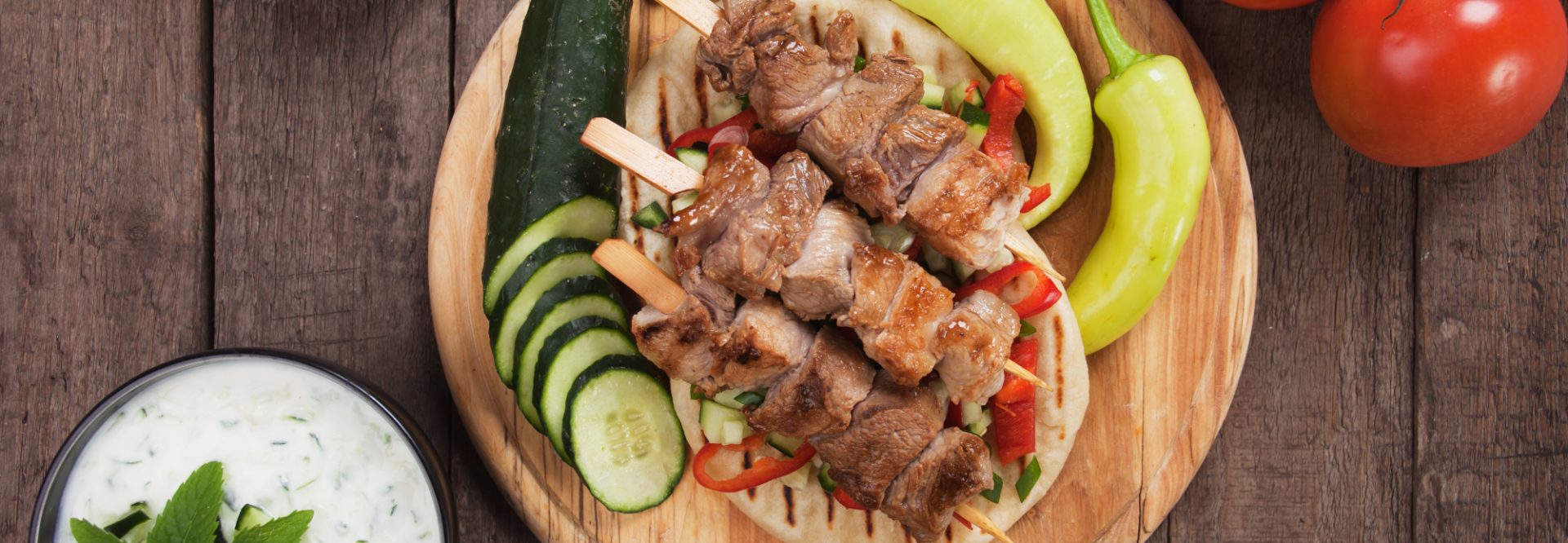 Souvlaki or kebab, meat skewer with pita bread and fresh vegetable