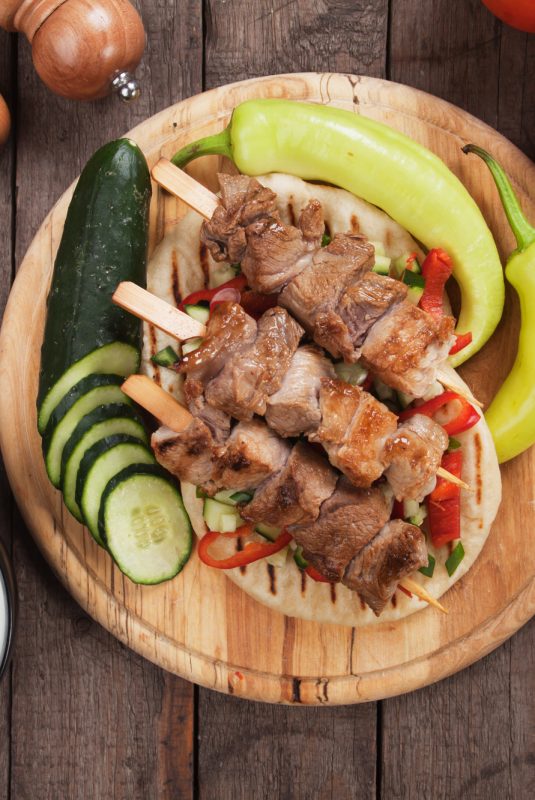 Souvlaki or kebab, meat skewer with pita bread and fresh vegetable