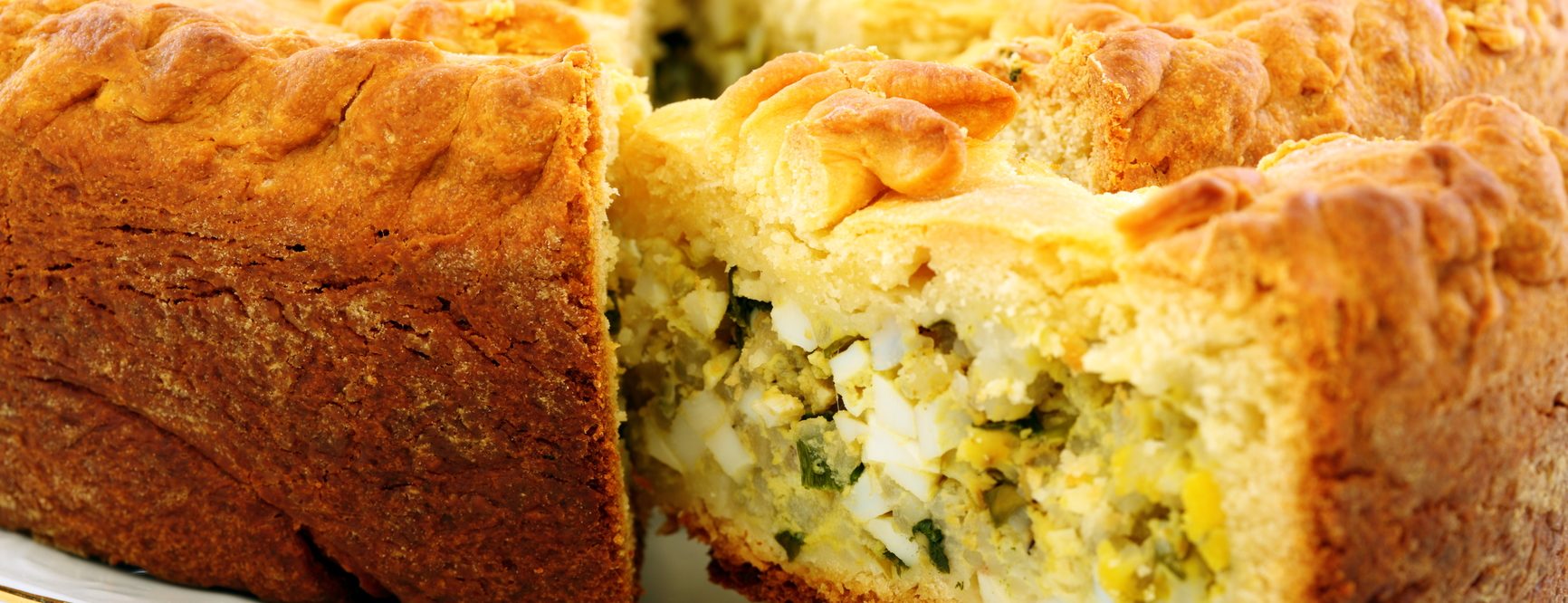Cake with eggs and greens.