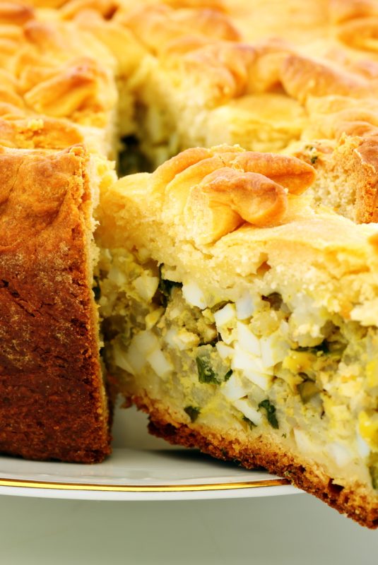 Cake with eggs and greens.